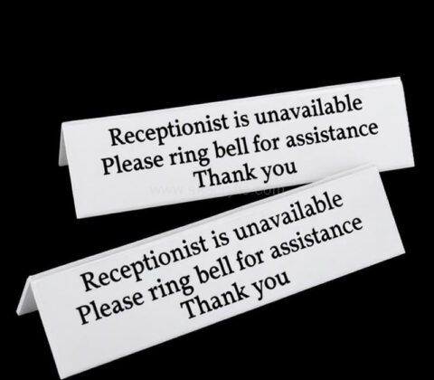 Custom acrylic sign on hotel reception desks